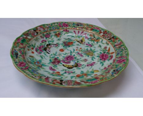 An 18th/19th century Chinese Canton Famille Rose plate decorated in enamel with butterflies representing 'long life', repaire