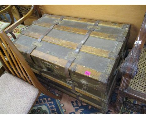 A late 19th/early 20th century brown canvas clad trunk with beech batons, metal corners, lock and brown leather straps, with 
