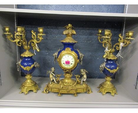 A reproduction blue painted metal, brass and plated Imperial clock set with candelabra side pieces