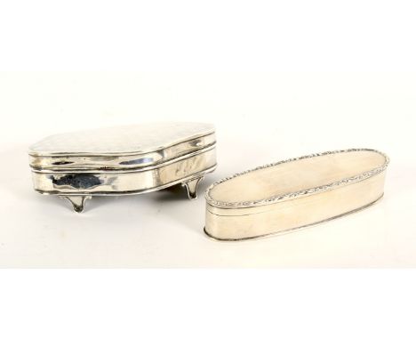 Two silver boxes and covers. The first of oval form with scroll cast border, hallmarked Birmingham, 1919, 14.3cm wide, the se
