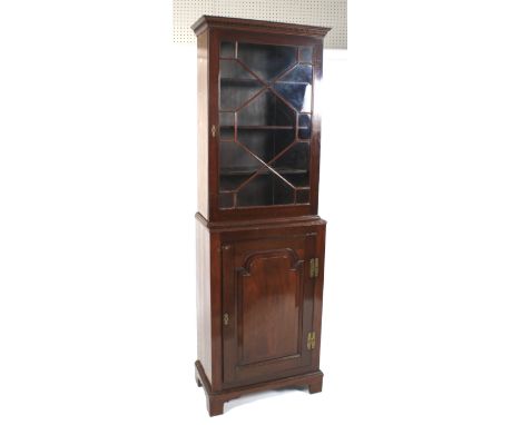 A 19th century mahogany bookcase on stand. The glazed astragal door enclosing three adjustable shelves, on a cupboard base wi