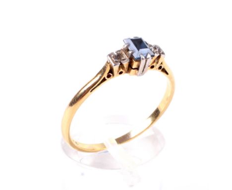 A mid-20th century gold, sapphire and diamond three stone ring. Centred with a small rectangular step-cut sapphire, claw set 