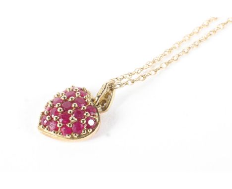 A 9ct gold and ruby encrusted heart-shaped pendant necklace and a pair of earrings. The first with a tiny diamond bail, hung 