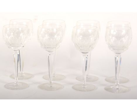 Eight Waterford cut wine glasses. With panel cut bowls, on faceted stems, 18.5cm high 