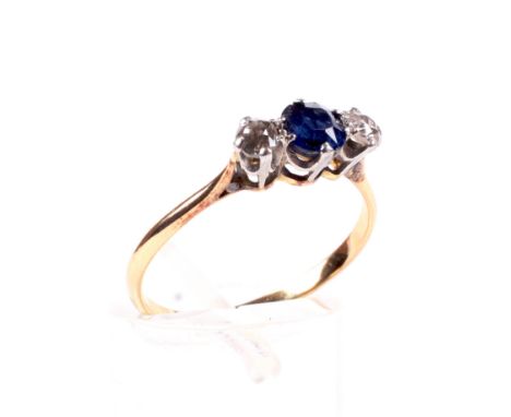 An early 20th century gold, sapphire and diamond three stone ring. Centred with a small round mixed-cut sapphire between smal