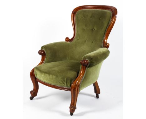 A Victorian mahogany framed upholstered armchair. With balloon shaped button back, upholstered in green velvet, within scroll