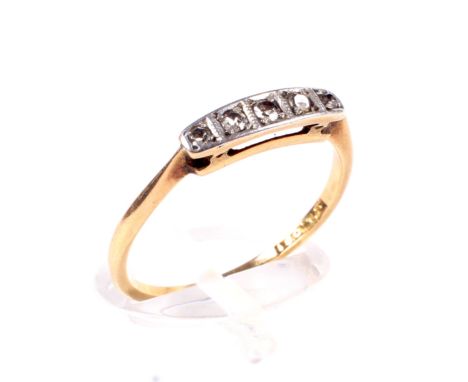 An Art Deco gold and diamond five stone ring. The slightly graduated eight-cut stones each grain-set within a platinum-flashe