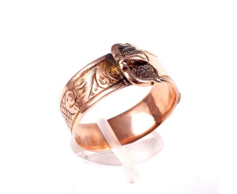 A late Victorian 9ct rose gold 'buckle' ring. The broad band engraved with foliate scrolls and diaper panels, hallmarks for B