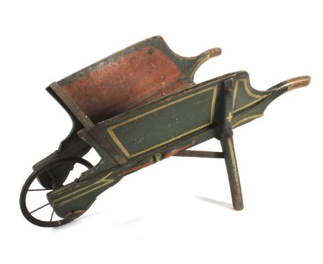 A small antique painted pine wheelbarrow. Painted in green and red with front spoked iron wheel, 70cm long  Condition Report: