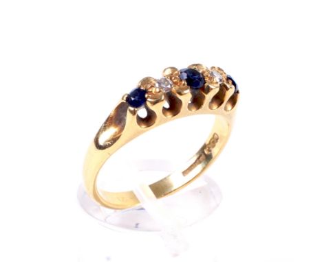 A vintage 18ct gold, sapphire and diamond five stone ring in Victorian style. The graduated stones all grain set to illusion-