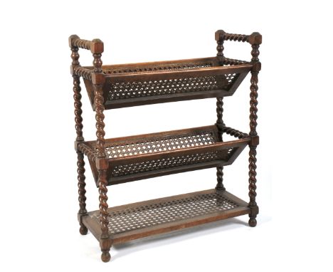 An Edwardian oak barley twist and cane small book shelf. With three V-shaped tiers on barley twist uprights and bun feet, L61