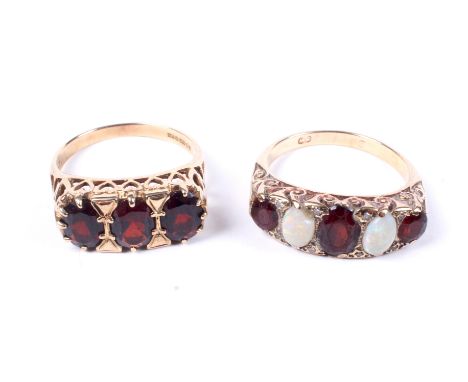 Two 9ct gold and garnet cast half-hoop rings. One set with three graduated oval garnets spaced by white opal cabochons and wi