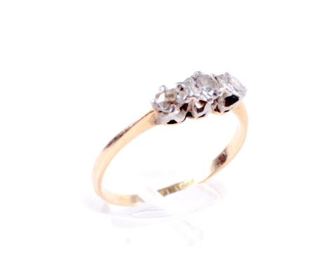 An early 20th century gold and diamond three stone ring. The graduated old-cut and modern round brilliants approx. 0.42cts to