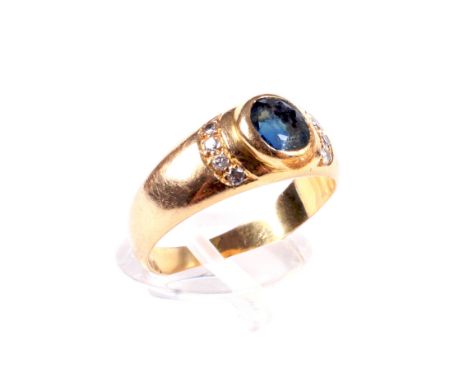 A Continental gold, sapphire and diamond dress ring. Rub-over set at the centre with an oval mixed-cut sapphire approx. 5.4mm