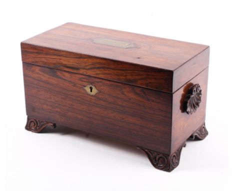 A 19th century rosewood carved tea caddy. The top with recessed brass handle, the interior fitted with two hinged caddies and