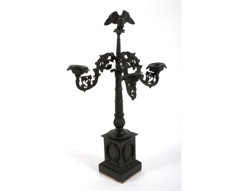 A French Empire style three-light candelabra, late 19th/early 20th century. Cast metal and weighted to base, with eagle finia