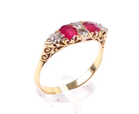 An early 20th century gold, ruby and diamond carved half-hoop ring in Victorian style. Centred with two early modern round br