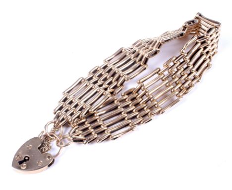 A vintage 9ct gold six-bar gate bracelet on a padlock clasp. Hallmarks for Birmingham 1966, approx. 17mm wide, 23.3 grams