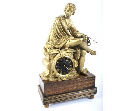 A late 19th/early 20th century French gilt-metal mounted striking mantel clock. Surmounted with a seated figure of a man hold