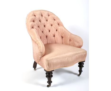 A Victorian button back pink silk upholstered armchair. With watered pink silk, on turned baluster legs and casters, 88cm hig