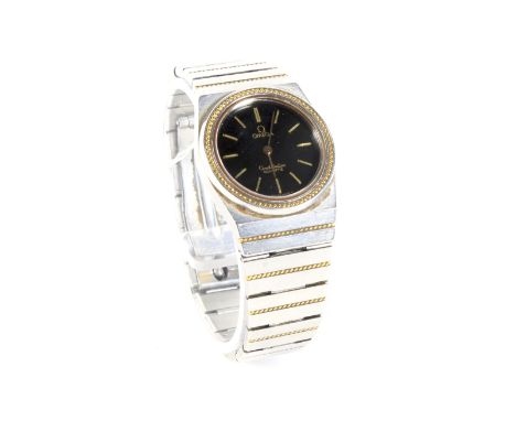 A vintage ladies Omega constellation quartz wristwatch. The black dial with gilt baton hour markers, on original bi colour st