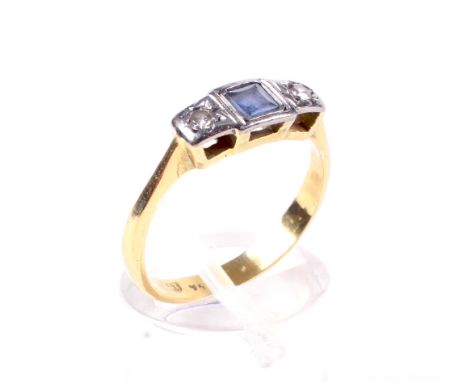 An early 20th century gold, blue stone and diamond three stone ring. Centred with a pale-blue square stone, between small eig