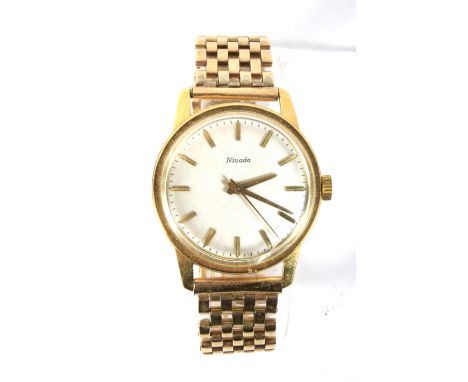 A vintage gents 18ct gold cased Nivada automatic wristwatch. The polished dial with gilt baton markers denoting hours, inside
