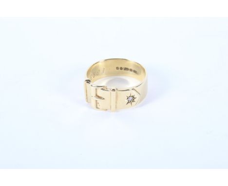 A gents 9ct gold buckle ring. Set with a single white stone, ring size U, 7.1g