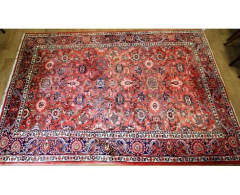 A large 20th century floor rug. Silk blend with a floral patterned panel to the centre and bordered with cream, blue and pink