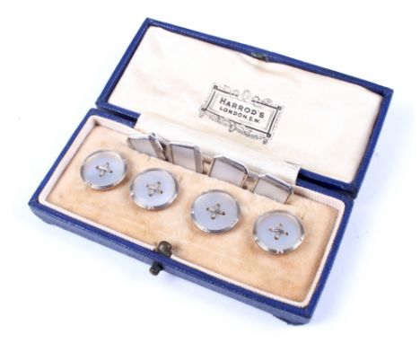 A set of four early 20th century gold and mother of pearl round buttons and a pair of cufflinks. The first, each centred with