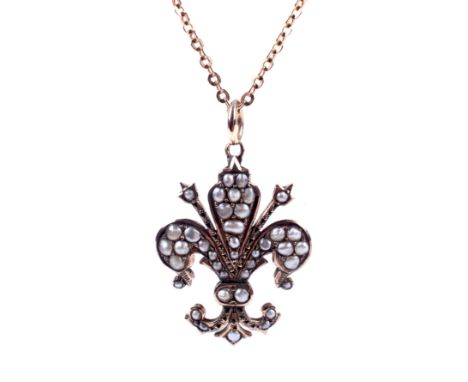 A fleur-de-lys pendant and chain. Comprising a vintage gold trace link chain on a bolt-ring clasp stamped '9ct', 43cm long, 3