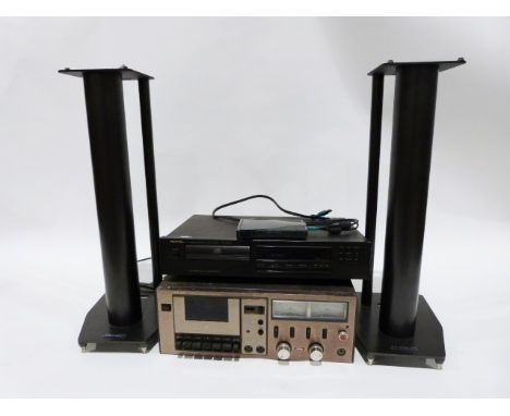 Rotel DVD player and a Teac stereo cassette deck and a pair of speaker stands