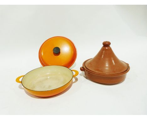 Le Creuset two-handled cast iron shallow dish and cover&nbsp;in orange enamel, 37cm wide over the handles and a terracotta ta