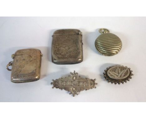 A silver vesta case with engraved decoration and blank cartouche, another a/f, a late Victorian silver panel brooch, another 