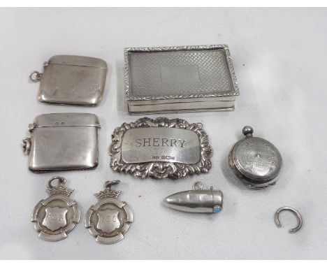 A bag containing two silver vesta cases, other small silver items and a white metal snuff box with gilt interior