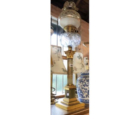 A large late 19th Century Duplex burner oil lamp with onyx and ormolu column, clear glass chimney, cut glass reservoir and fr