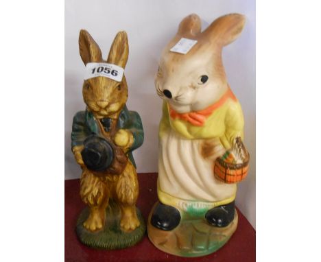 An old cellulose finish ceramic money box depicting a mother rabbit holding a basket containing carrots - sold with a similar