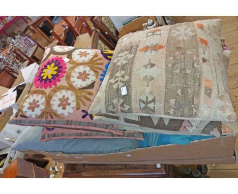 A box containing a quantity of embroidered tapestry and other cushions, Indian fabrics, etc.