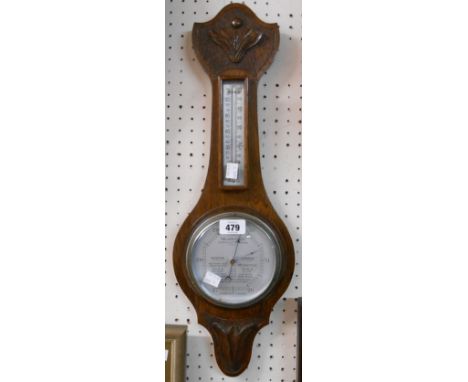A 20th Century polished and carved oak framed 'Weathertide' banjo barometer/thermometer with aneroid works