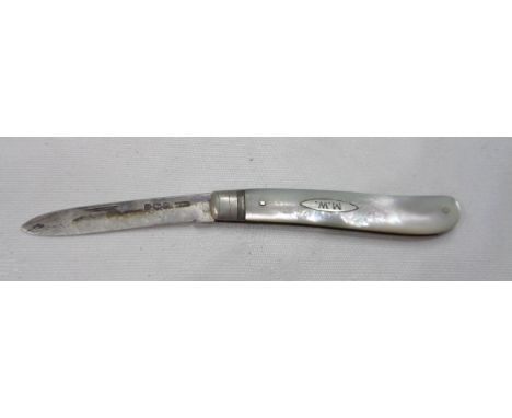 A silver bladed fruit knife with mother-of-pearl clad handle and 'M.W.' initials to cartouche