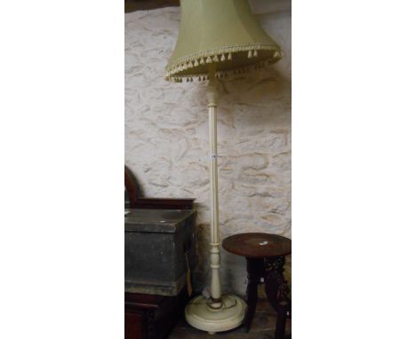 A vintage white painted standard lamp, set on a turned and fluted pillar and circular base