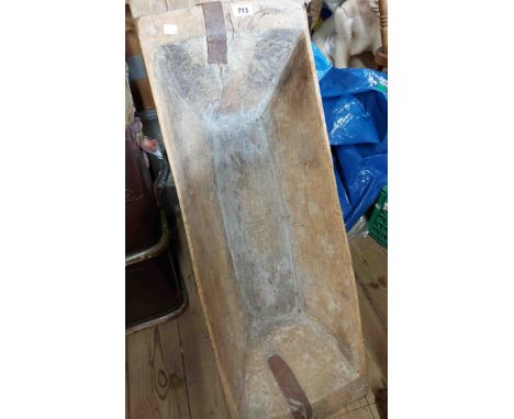 An antique wooden dough trough with metal strapwork