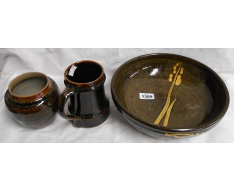 A large Winchcombe Pottery bowl with slip decoration on a brown hare's fur glaze - sold with a stoneware tankard with tenmoku