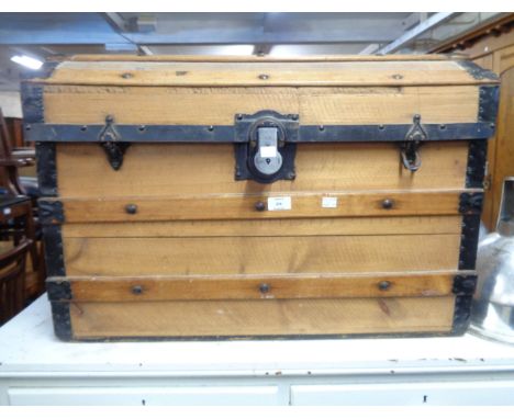 A 75.5cm late Victorian metal bound pine dome top trunk with flanking iron drop handles - lid detached