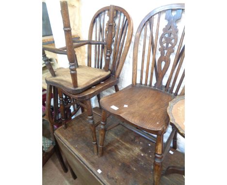Three matching vintage wheel back standard chairs with moulded solid elm seats, set on turned supports