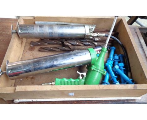 A drawer containing a quantity of assorted tools including two vintage grease guns, auger bits, etc.