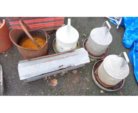 A quantity of assorted metalware comprising three Eltex chicken feeders, a cast iron helmet coat scuttle and a small feeding 