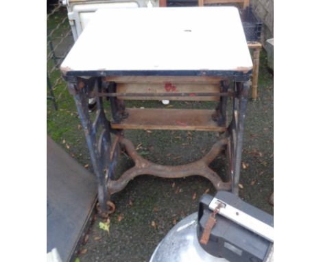 An old metamorphic table mangle with enamelled top surface, set on a cast iron base - by Gamages