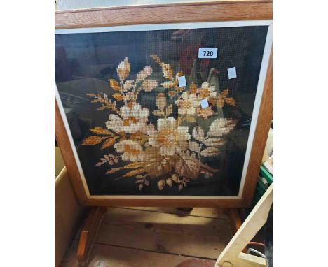 An oak firescreen with inset floral tapestry