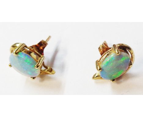 A pair of 375 (9ct.) gold stud earrings, each set with oval opal panel
